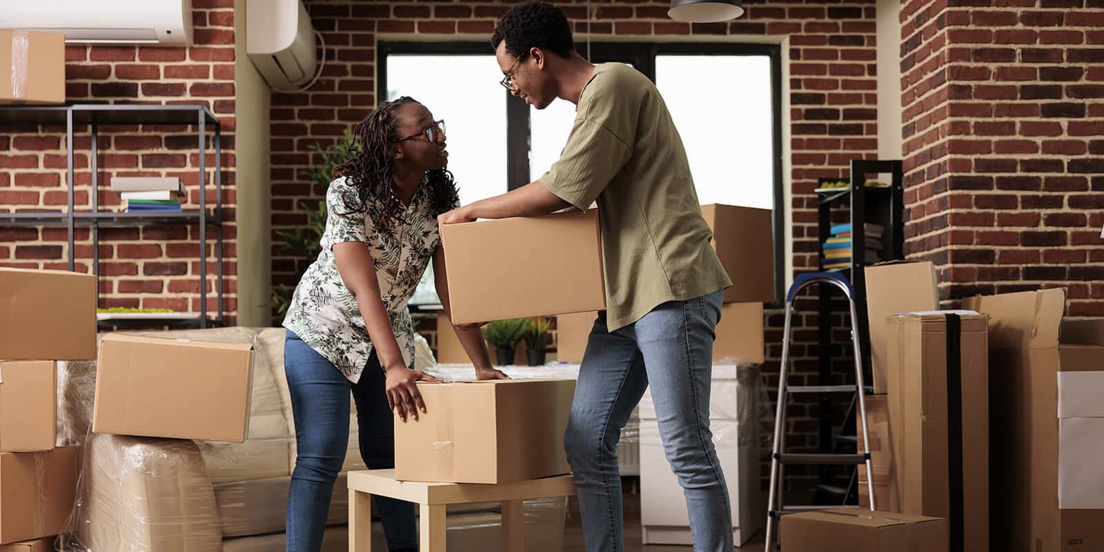 Couple packing moving boxes for safe relocation of fragile and valuable items